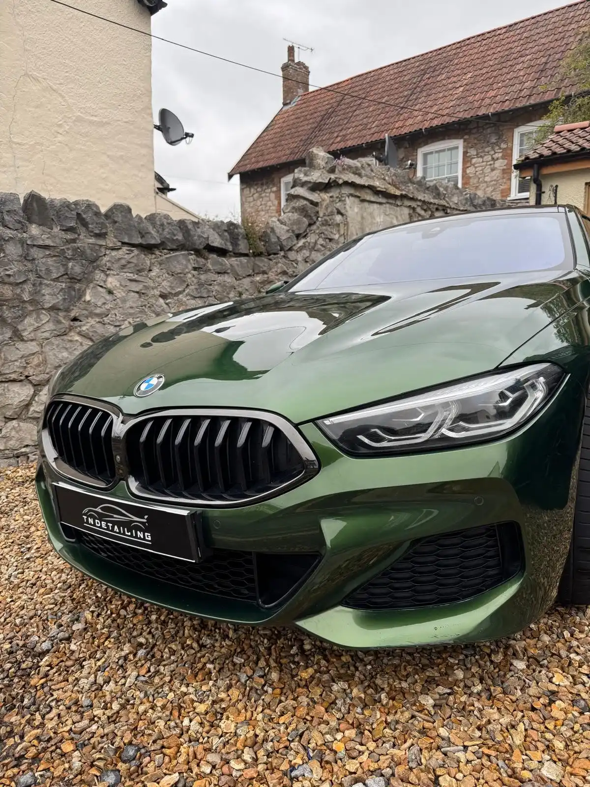 Green BMW 8 Series Gran Coupe from the front, showing the reflections in the bonnet and a TNDetailing plate