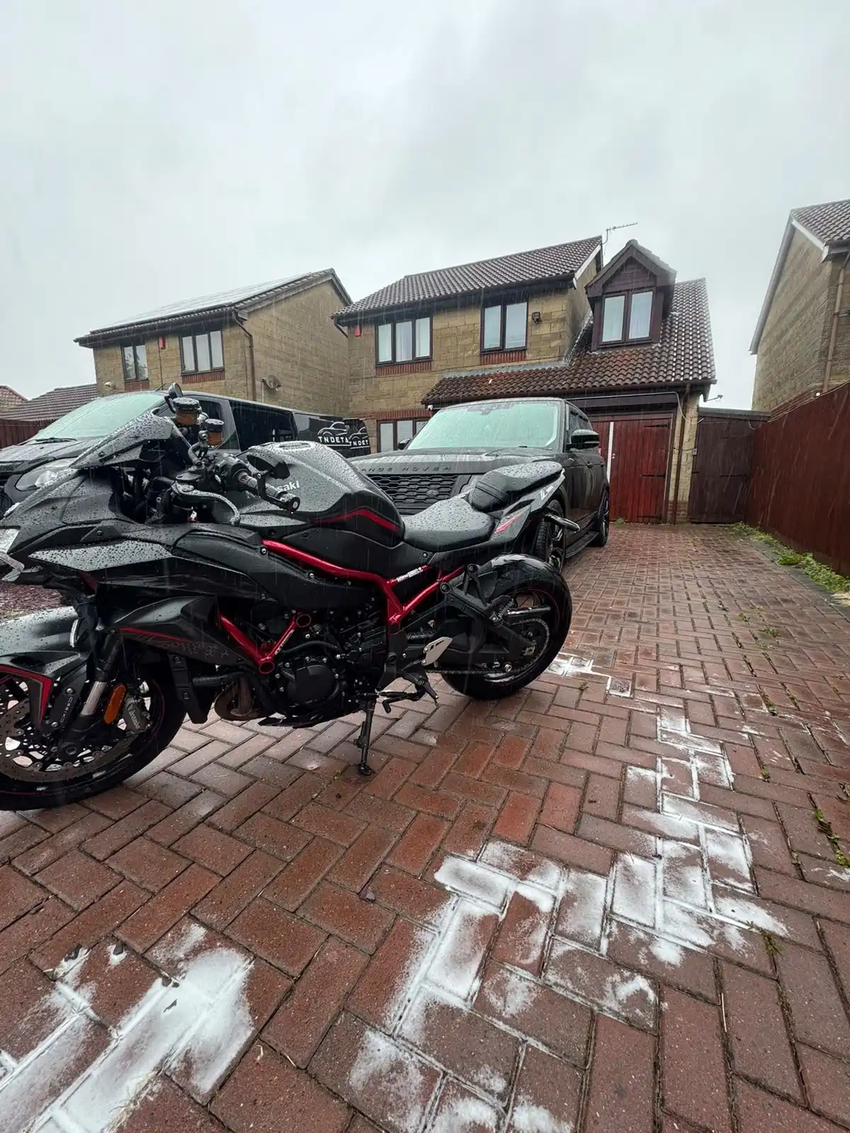 Black and red Kawasaki Z H2 motorbike from the side, showing the gloss black bodywork and red frame