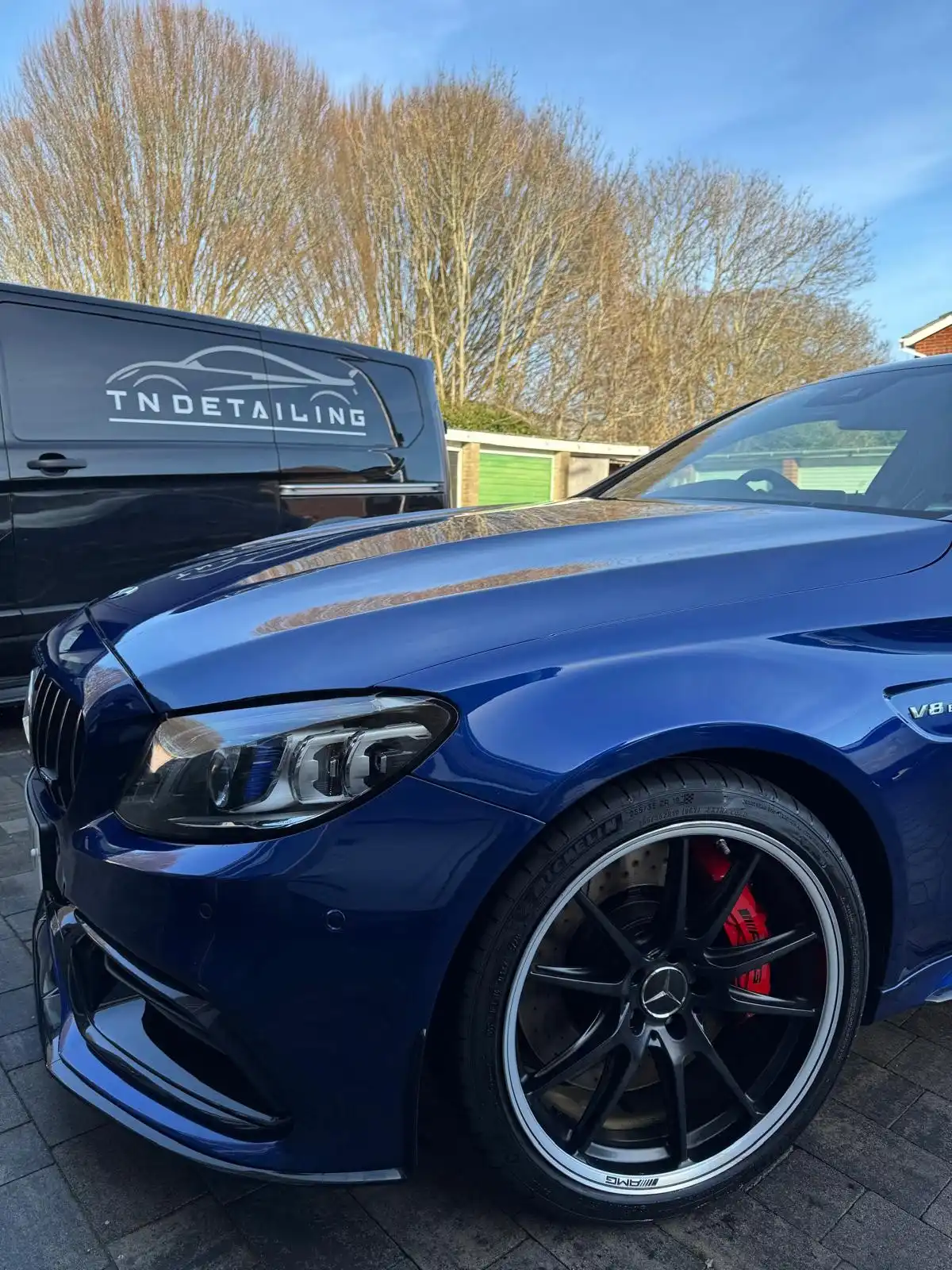 Blue Mercedes-AMG C63 coupe from a low front quarter, showing the gloss on the bonnet and wing and the red brake calipers