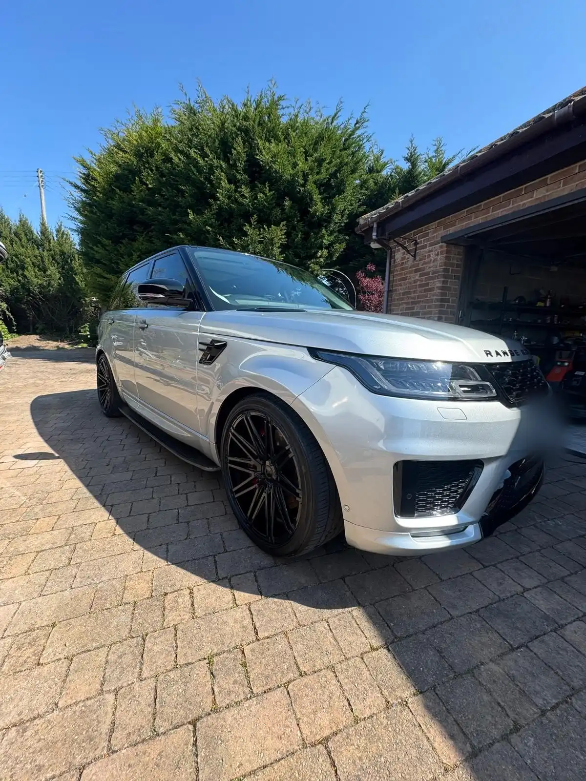 Silver Range Rover Sport from the front quarter, showing the finish on the silver paint and the dark alloy wheels