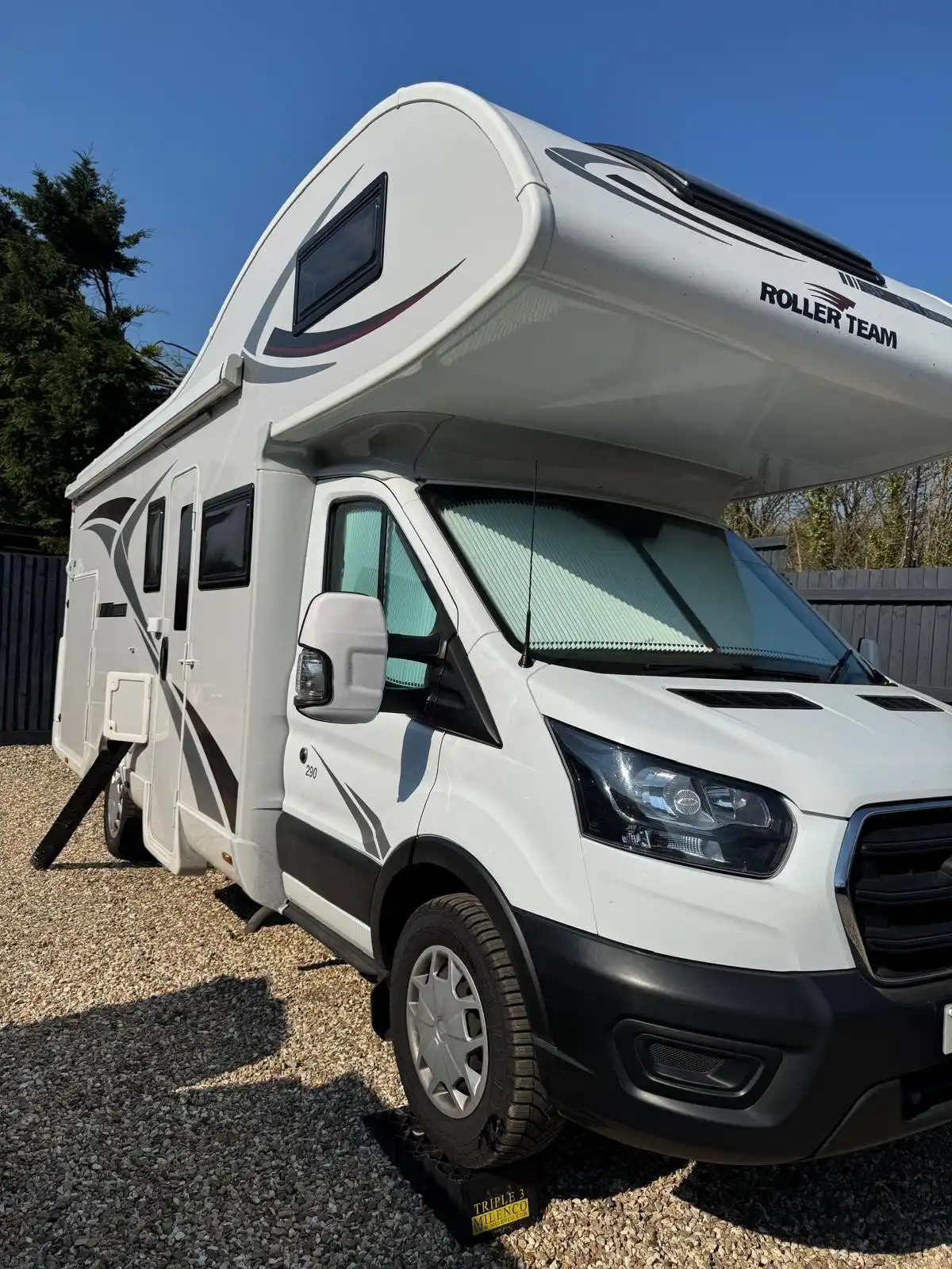 White Roller Team motorhome from the front quarter, showing the clean cab, bodywork and graphics