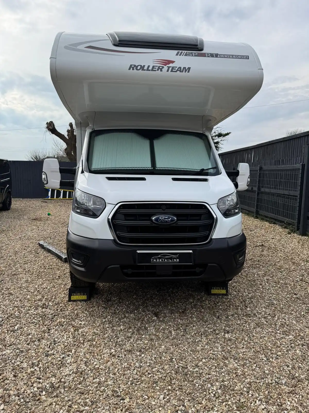 White Roller Team motorhome seen head on, showing the cab front and the luton above it