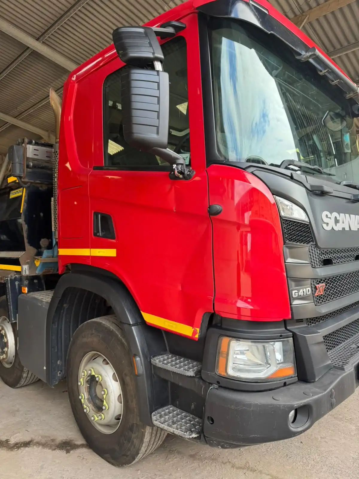 Red Scania G410 XT lorry cab, front quarter view, an example of a commercial vehicle